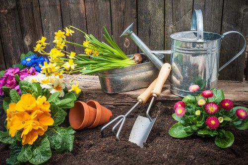 Garden clearance work with green waste piled for disposal